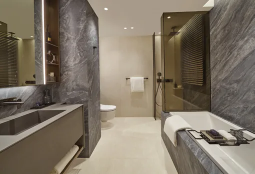 Union Square Residences, for illustration only: master bathroom with stone walls, a vanity with integrated basin and a bathtub